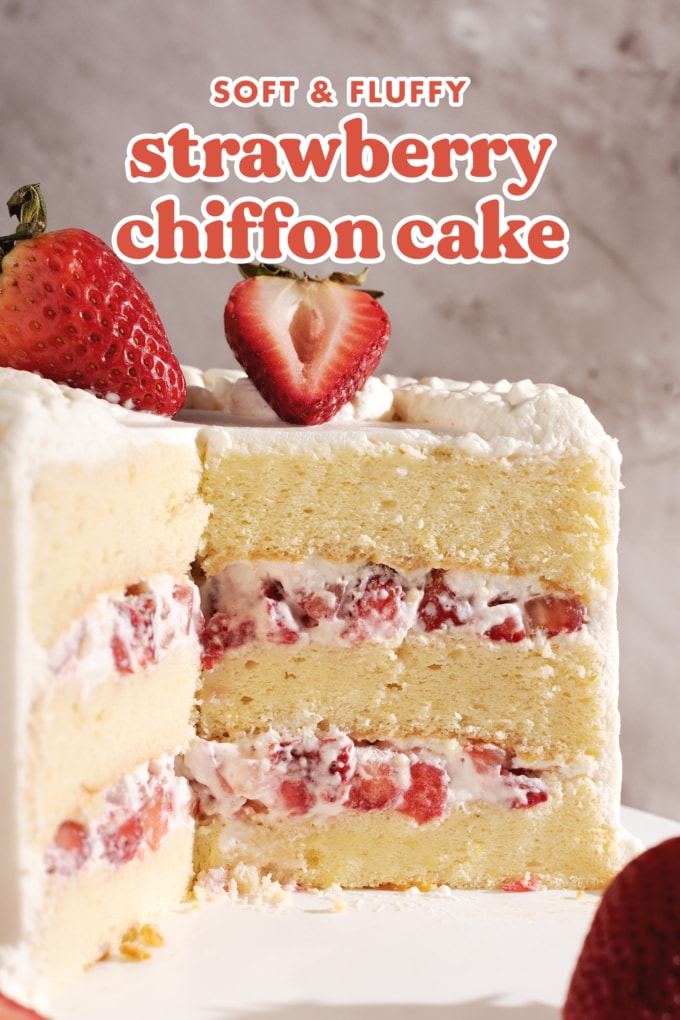 Cross-section of cake showing layers of chiffon cake, whipped cream, and strawberries inside.