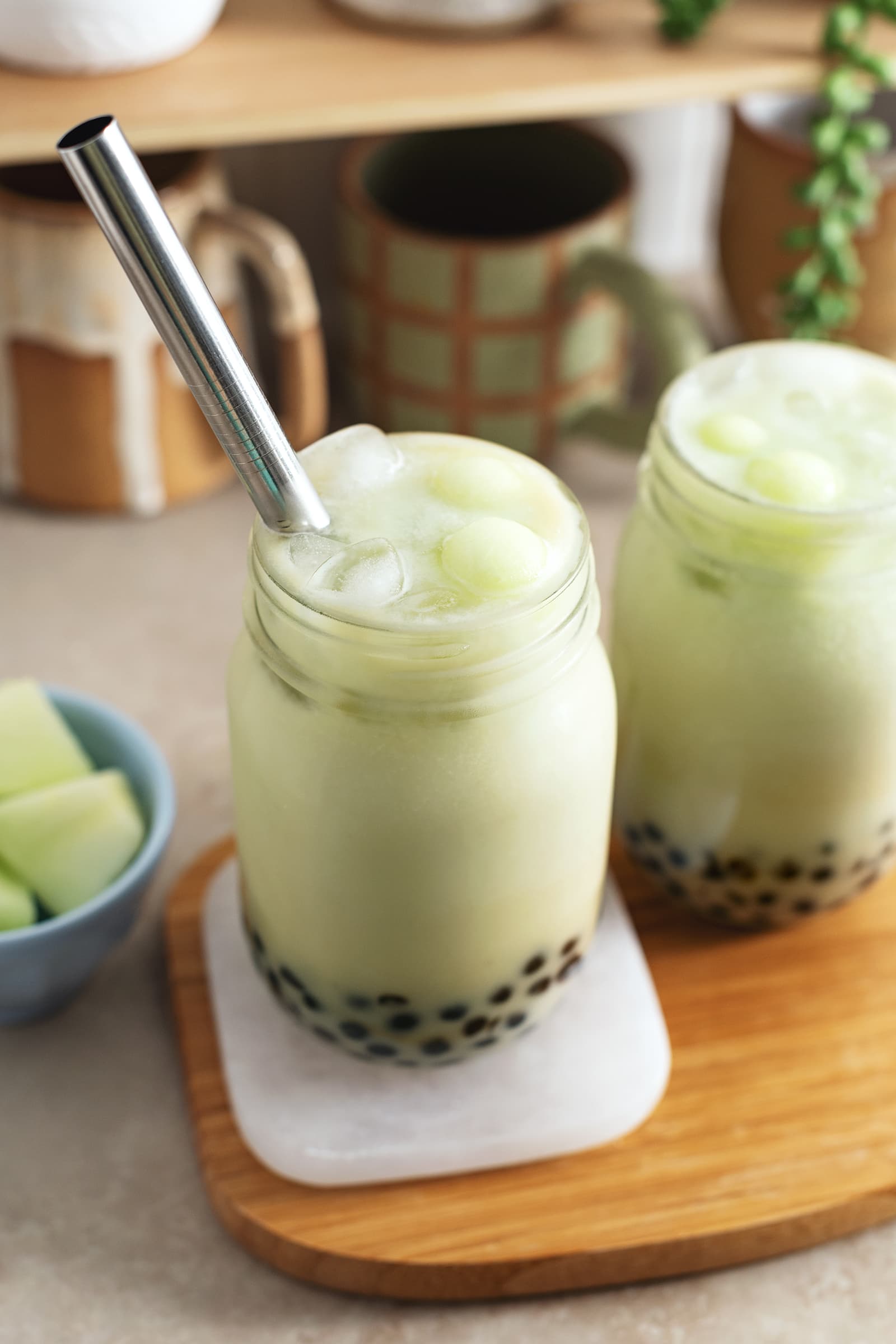 Glasses of bubble tea with metal straw.
