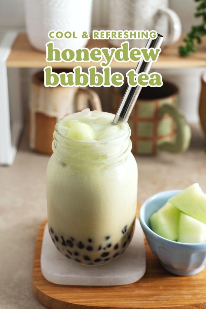 Mason jar glass of honeydew bubble tea on a coaster.