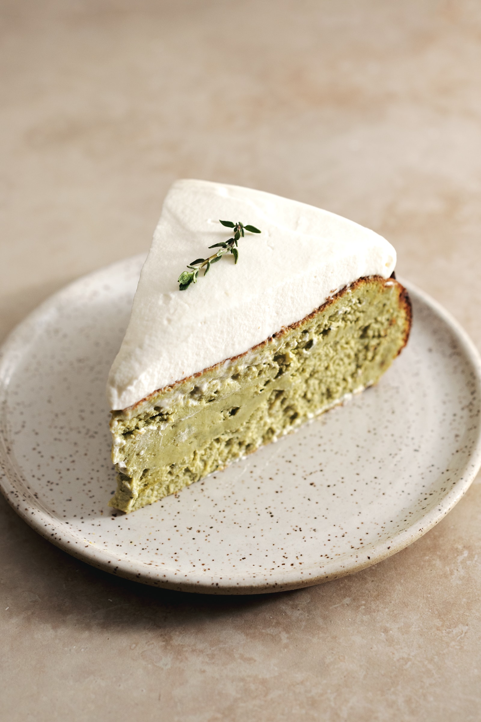 A slice of matcha cheesecake on a plate.