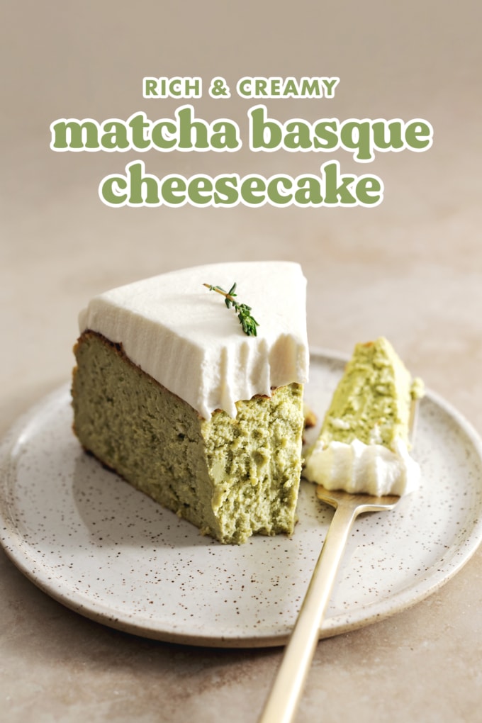 A slice of matcha basque cheesecake on a plate with a chunk taken out of it by the fork resting next to it.