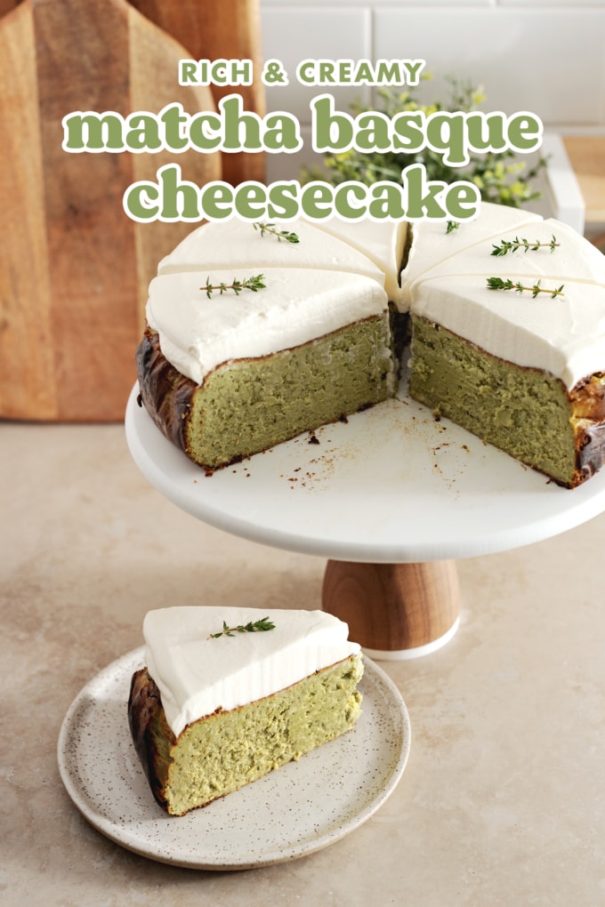 A slice of matcha basque cheesecake on a plate and the rest of the cake on a cake stand.