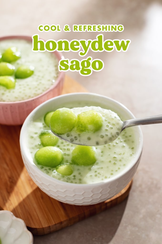 A spoonful of honeydew sago and two melon balls held above a bowl.
