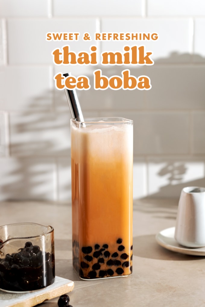 Thai milk tea boba in a rectangular glass with metal straw.