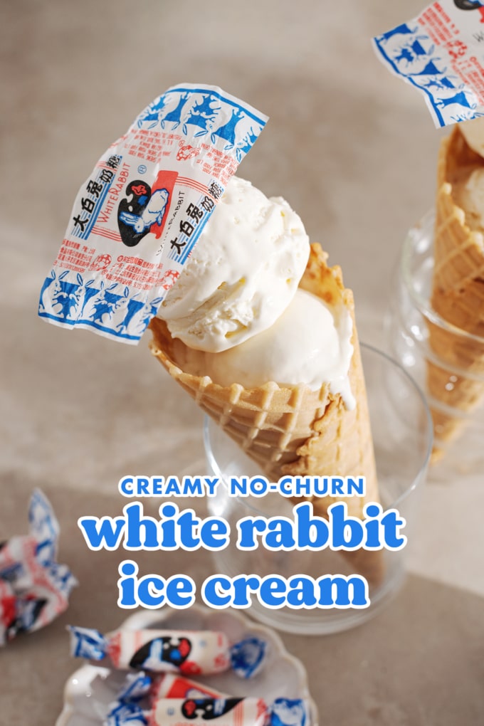 White rabbit ice cream cone in a glass with candy wrapper on top of it.