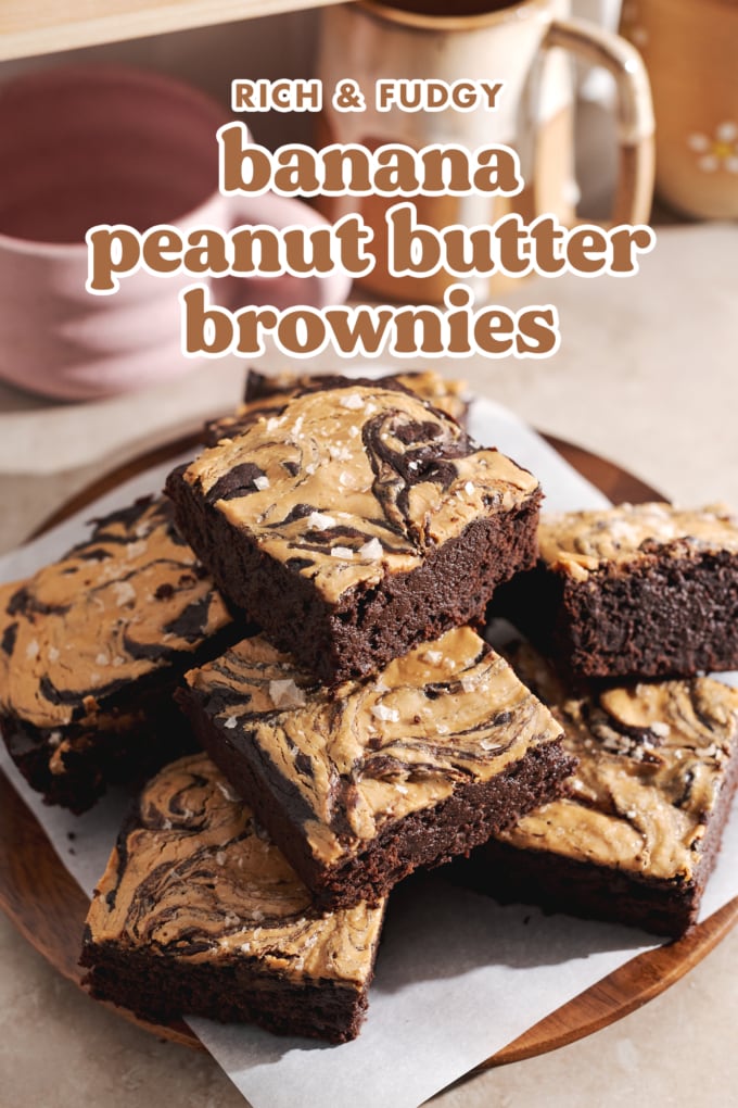 A stack of peanut butter brownies on a plate with mugs in the back.