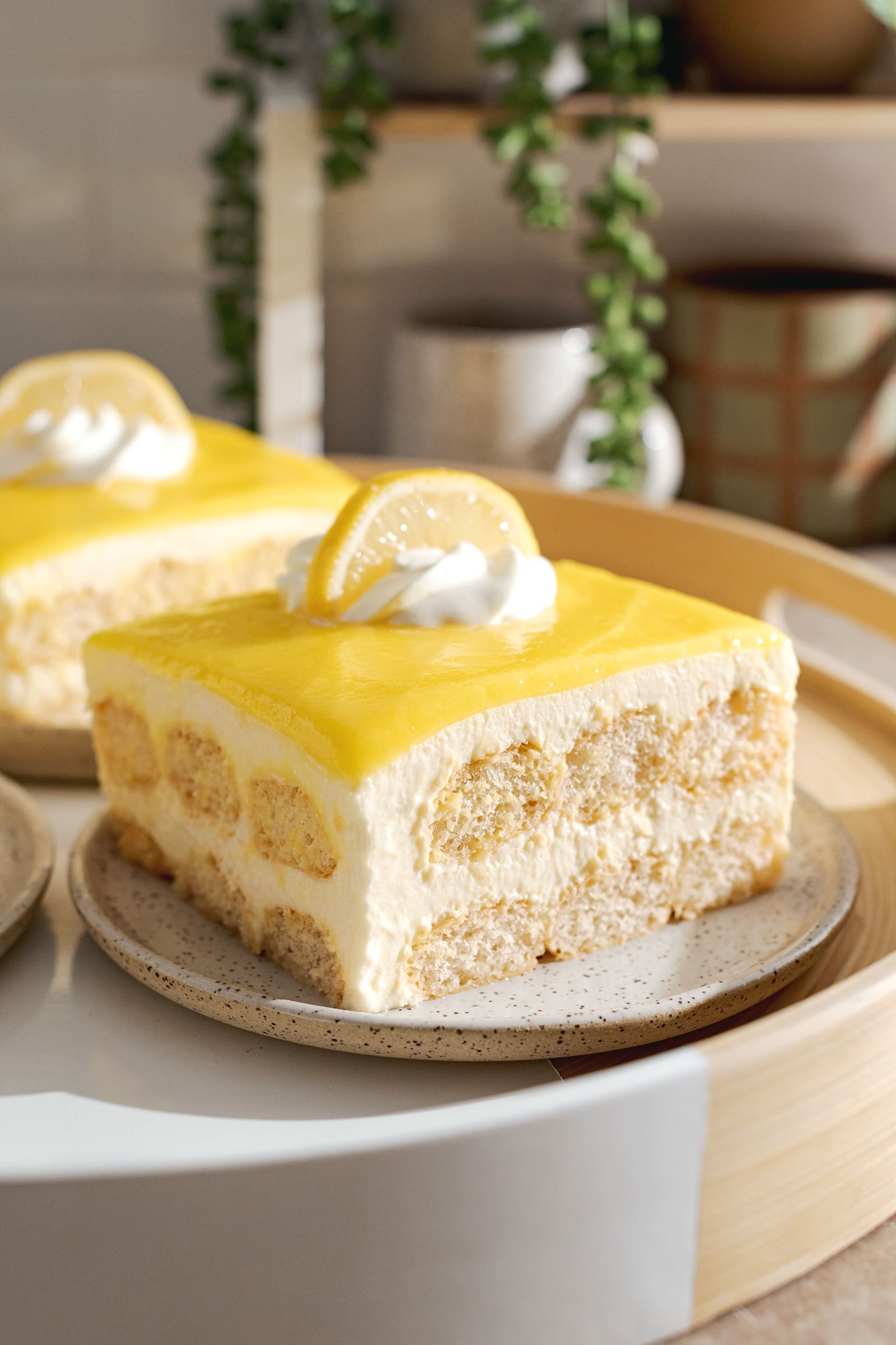 A slice of lemon curd tiramisu on a plate showing the layers inside.