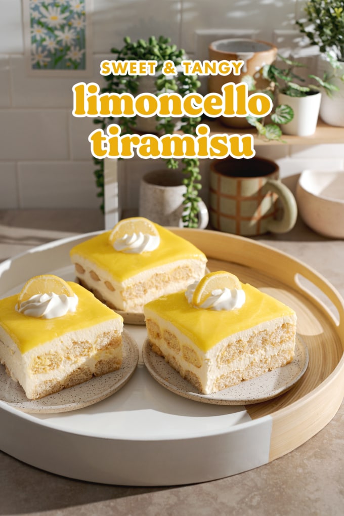 Three slices of limoncello tiramisu on a round platter in front of a shelf with plants and mugs.