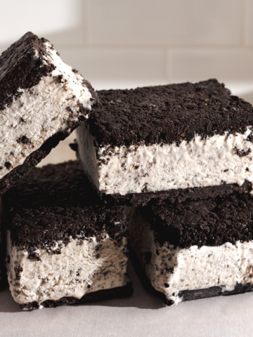 Oreo ice cream sandwiches stacked on top of each other.