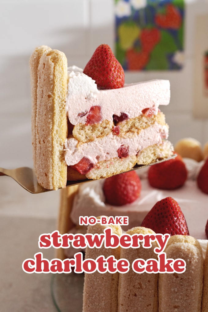 A slice of strawberry cake lifted from the rest of the cake.