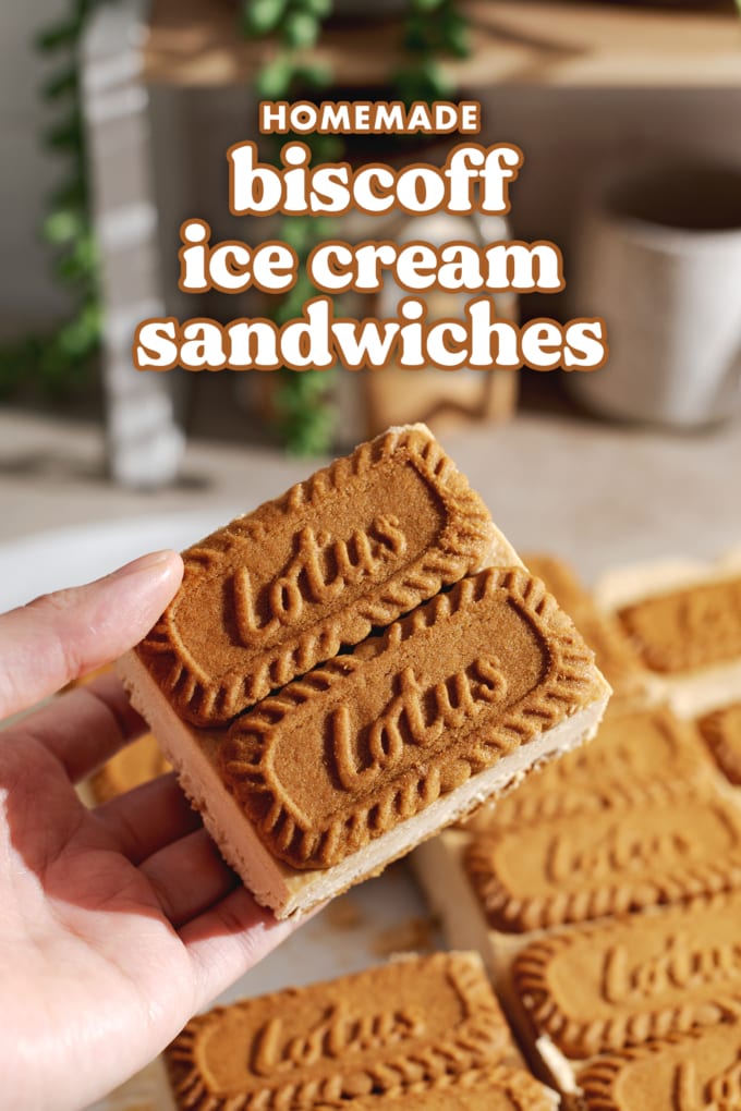 Hand holding ice cream sandwich with two biscoff cookies on top in front of the rest of the sandwiches.