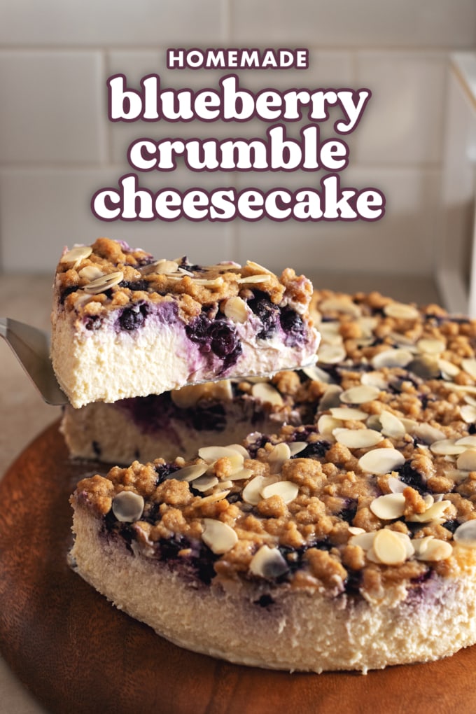 A slice of cheesecake lifted from the rest of the cheesecake.