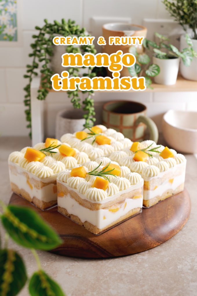 Individual containers of mango tiramisu on a kitchen counter with shelf in the back.