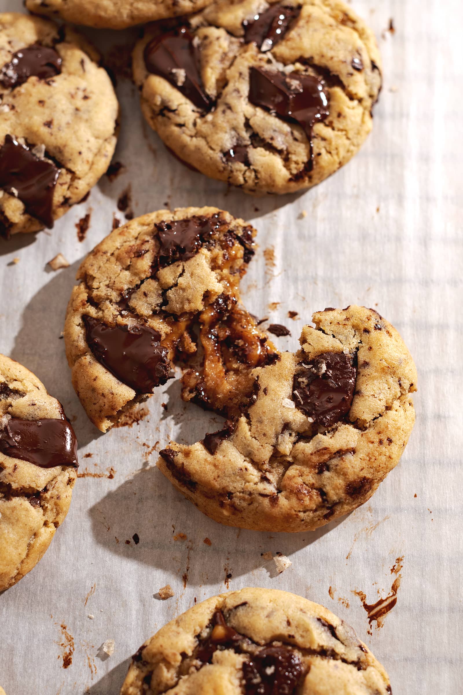 A miso caramel stuffed cookie pulled apart to show gooey caramel filling inside.
