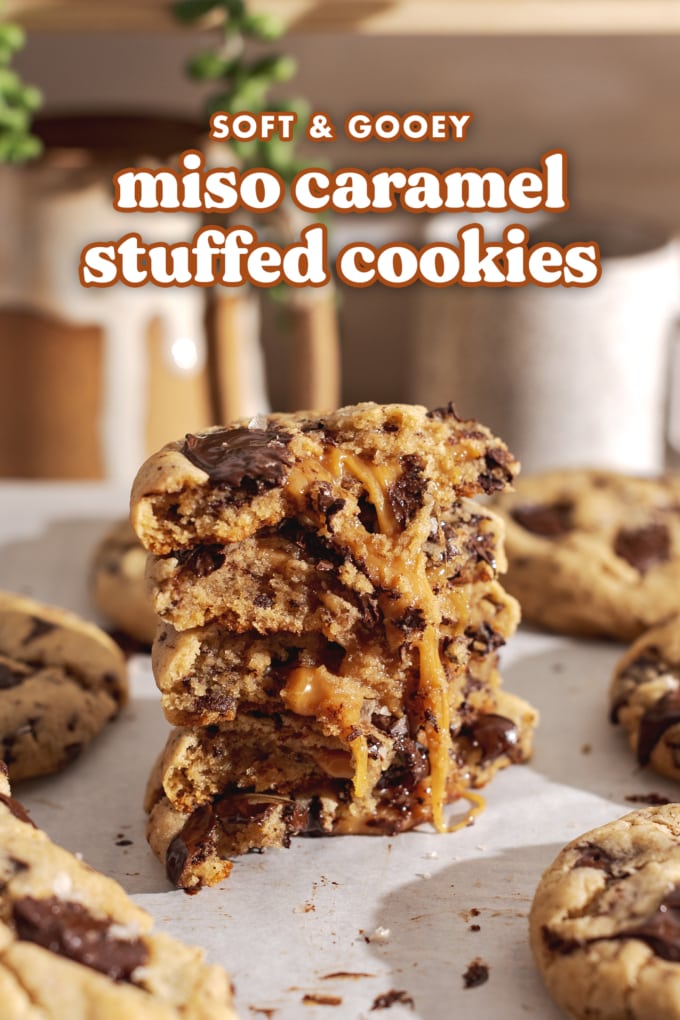 A stack of miso caramel cookies cut in half to show the goey caramel inside.