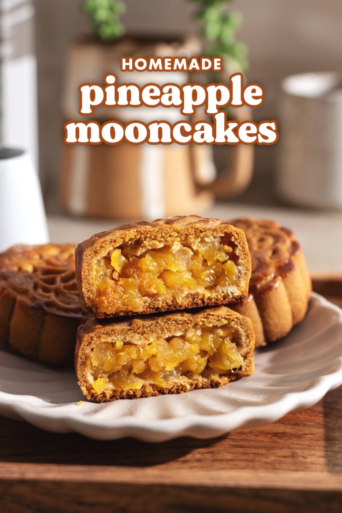 Pineapple mooncake cut in half with both halves stacked on top of each other to show pineapple filling inside.
