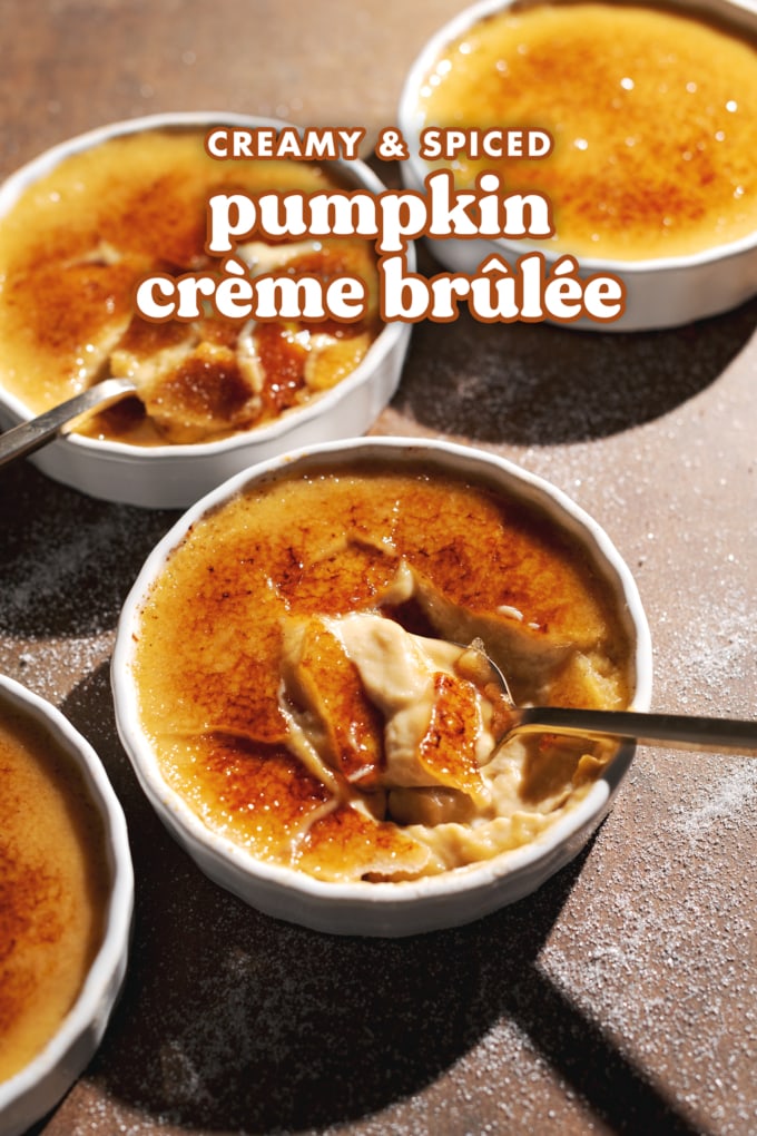 Ramekins of crème brûlée cracked with spoons to show the custard inside.