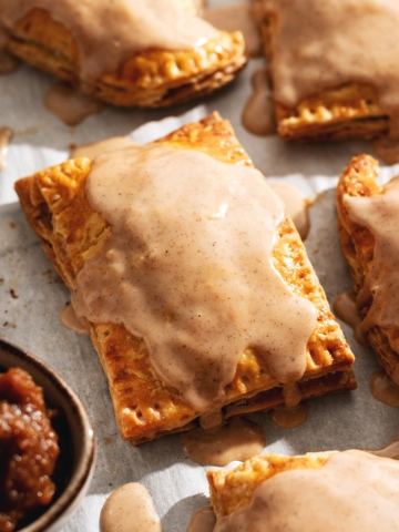 Pumpkin pop tarts with icing dripping down the sides.