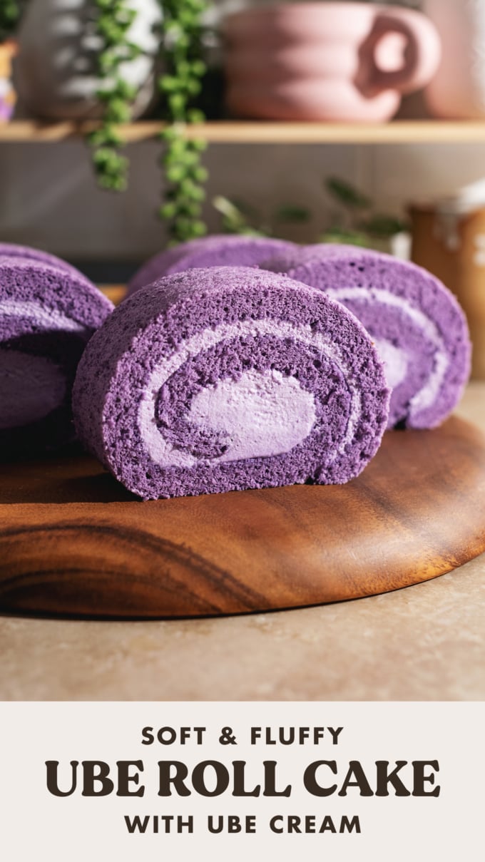 Slices of ube swiss roll arranged on a wooden platter.