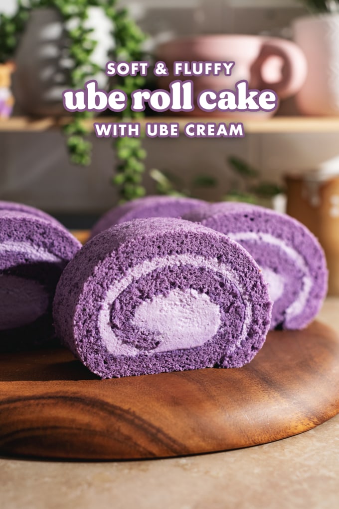 Slices of ube swiss roll arranged on a wooden platter.
