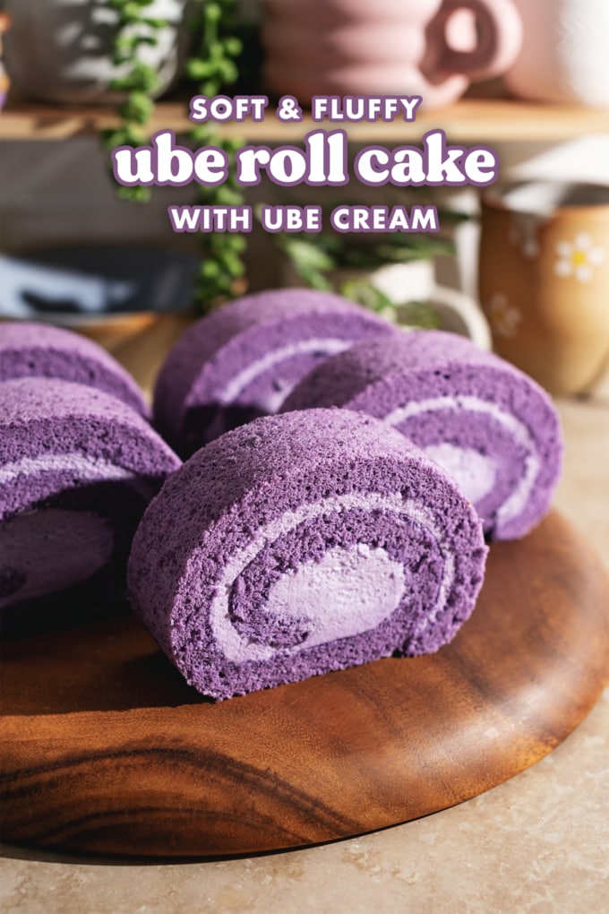 Slices of ube cake rolls lined up on a wooden platter.