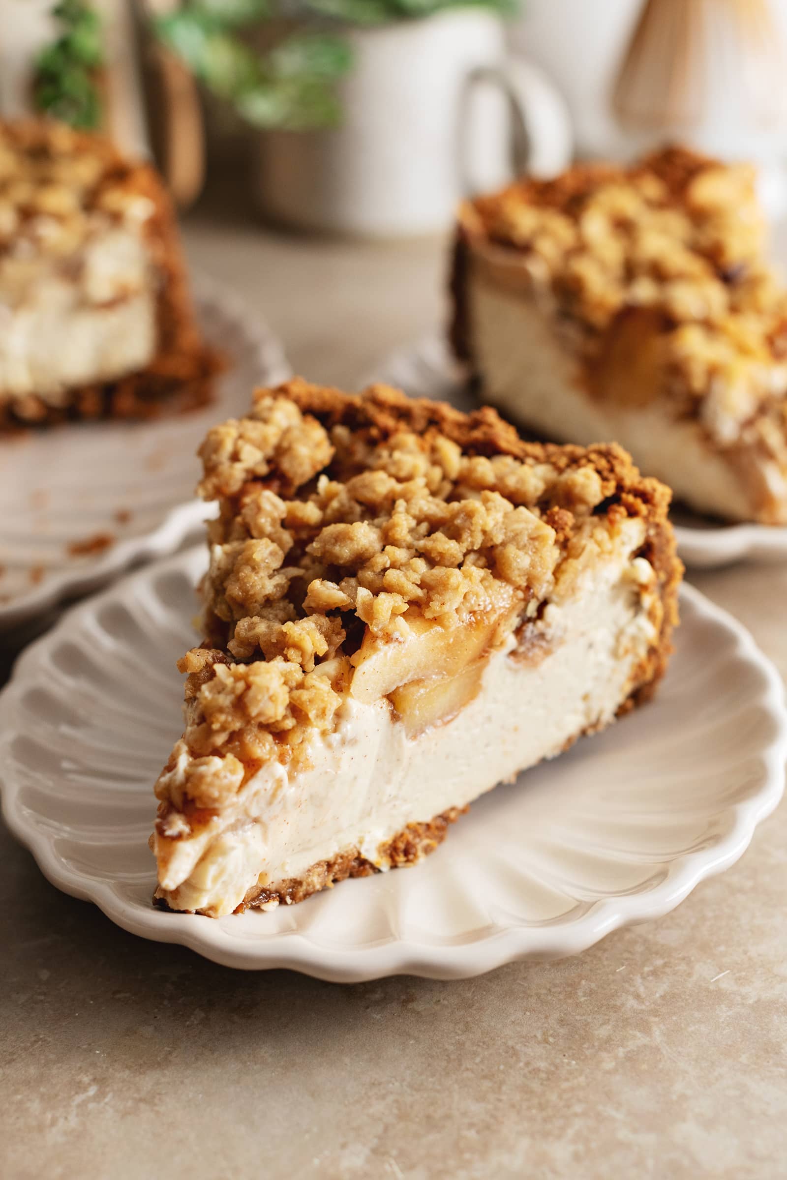 A slice of apple crumble cheesecake on a plate.