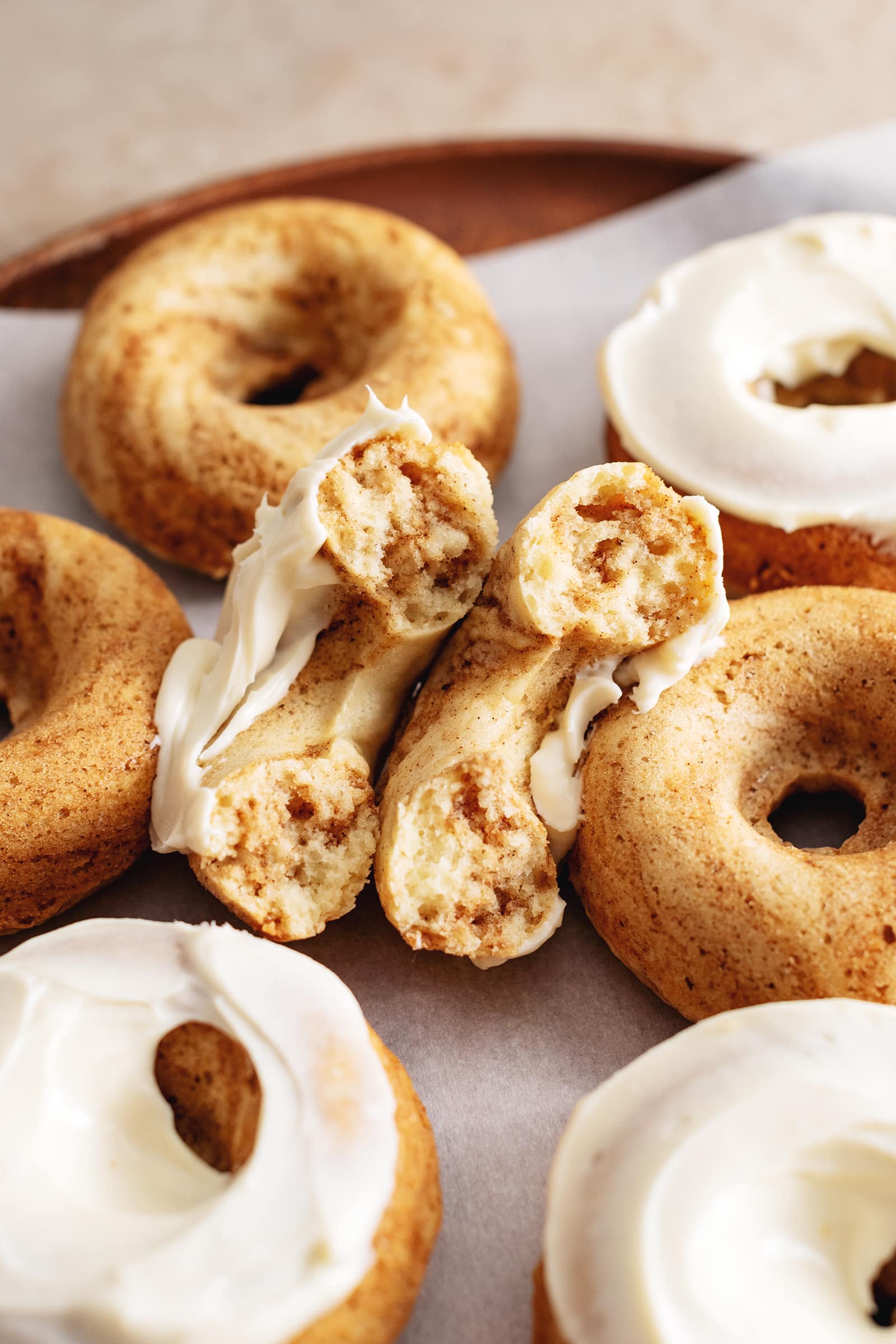 A cinnamon roll donut cut in half to show the texture inside.