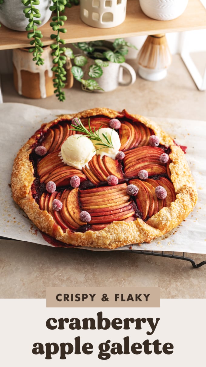 A cranberry apple galette sitting on a wire rack on a kitchen counter.