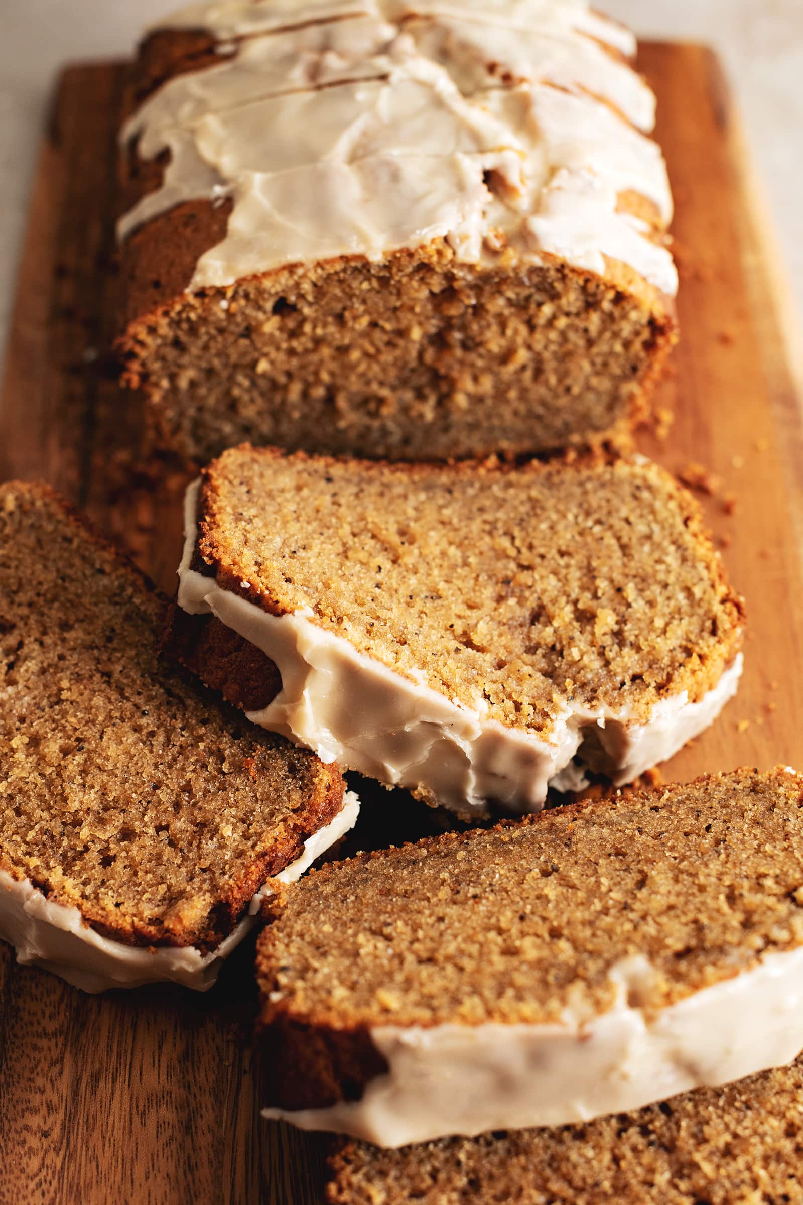 Slices of earl grey pound cake laying on a wooden board.