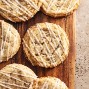 Earl grey sugar cookies scattered on a wooden board.
