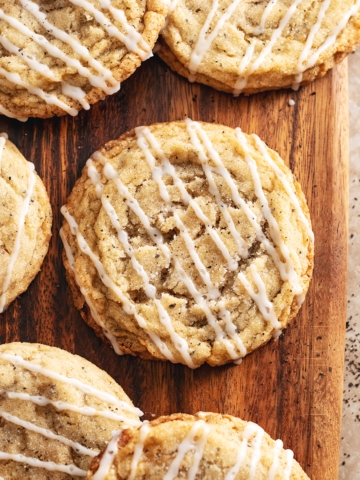 Earl grey sugar cookies scattered on a wooden board.