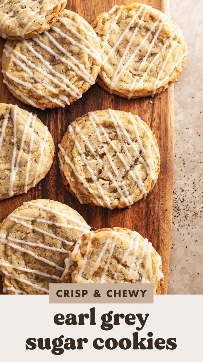 Earl grey sugar cookies scattered on a wooden board.