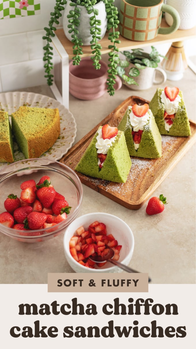 Matcha chiffon cake sandwiches on a wooden platter surrounded by bowls of strawberries.