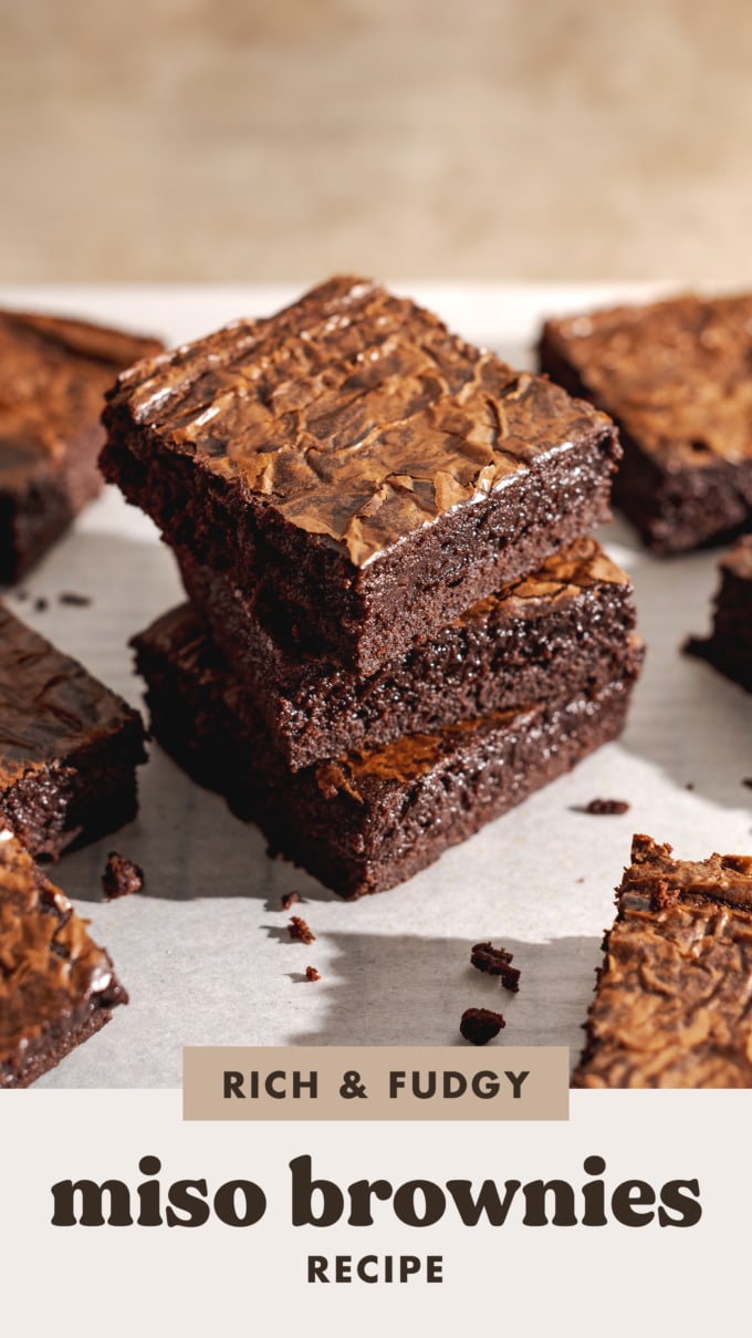 A stack of three miso brownies on parchment paper.