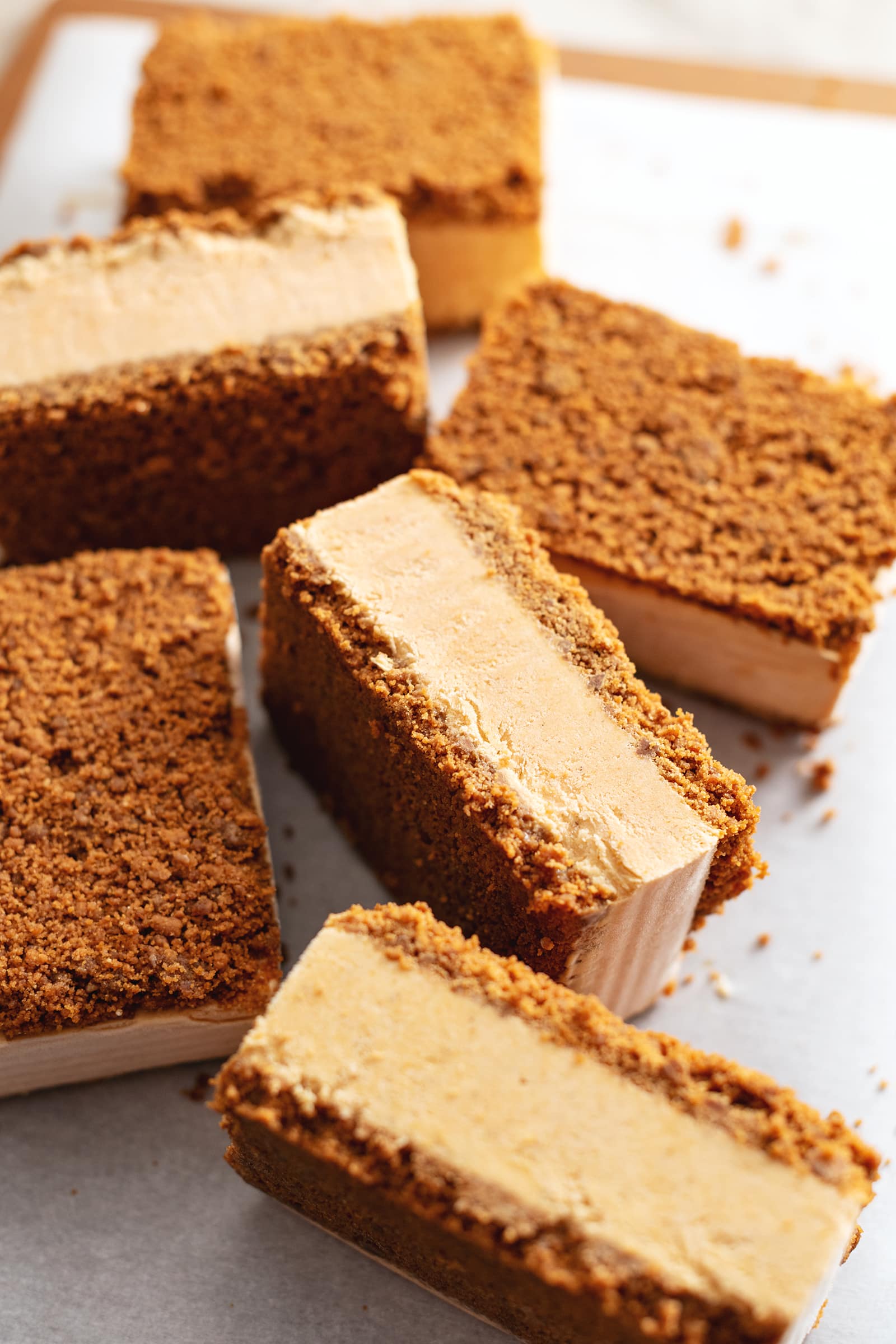 Ice cream sandwiches turned on their sides to show their crust and ice cream layers.