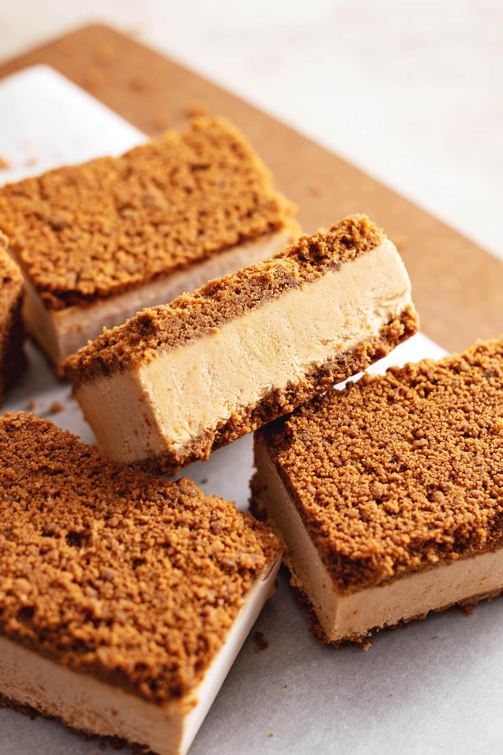 A pumpkin pie ice cream sandwich resting on another sandwich.