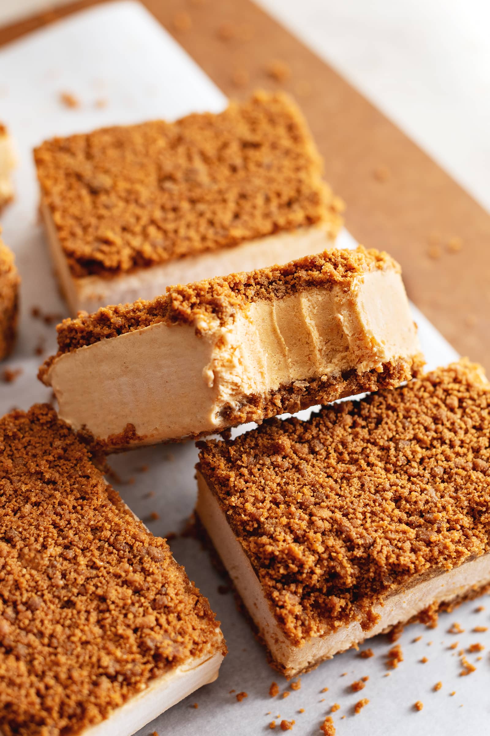 A bite taken out of a pumpkin pie ice cream sandwich.