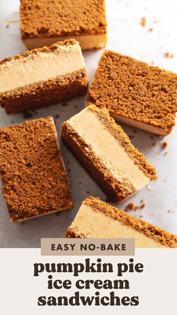 Pumpkin pie ice cream sandwiches scattered on parchment paper with some turned on their sides.