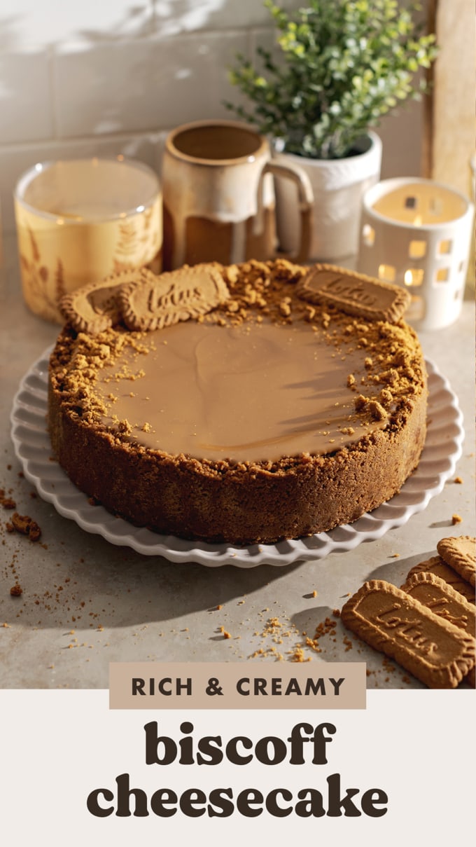 A whole biscoff cheesecake on a scalloped plate.