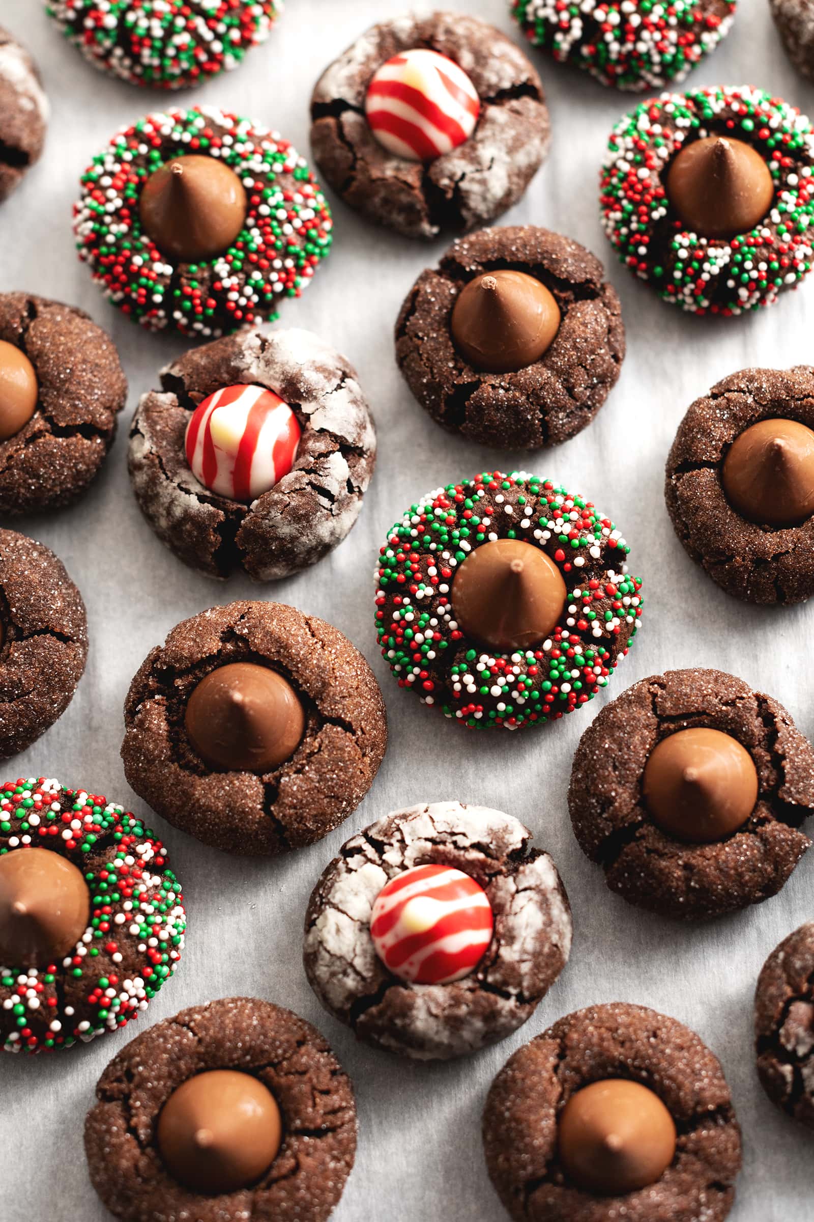 Top down view of chocolate blossom cookies with various coatings and Hershey's kiss flavour.