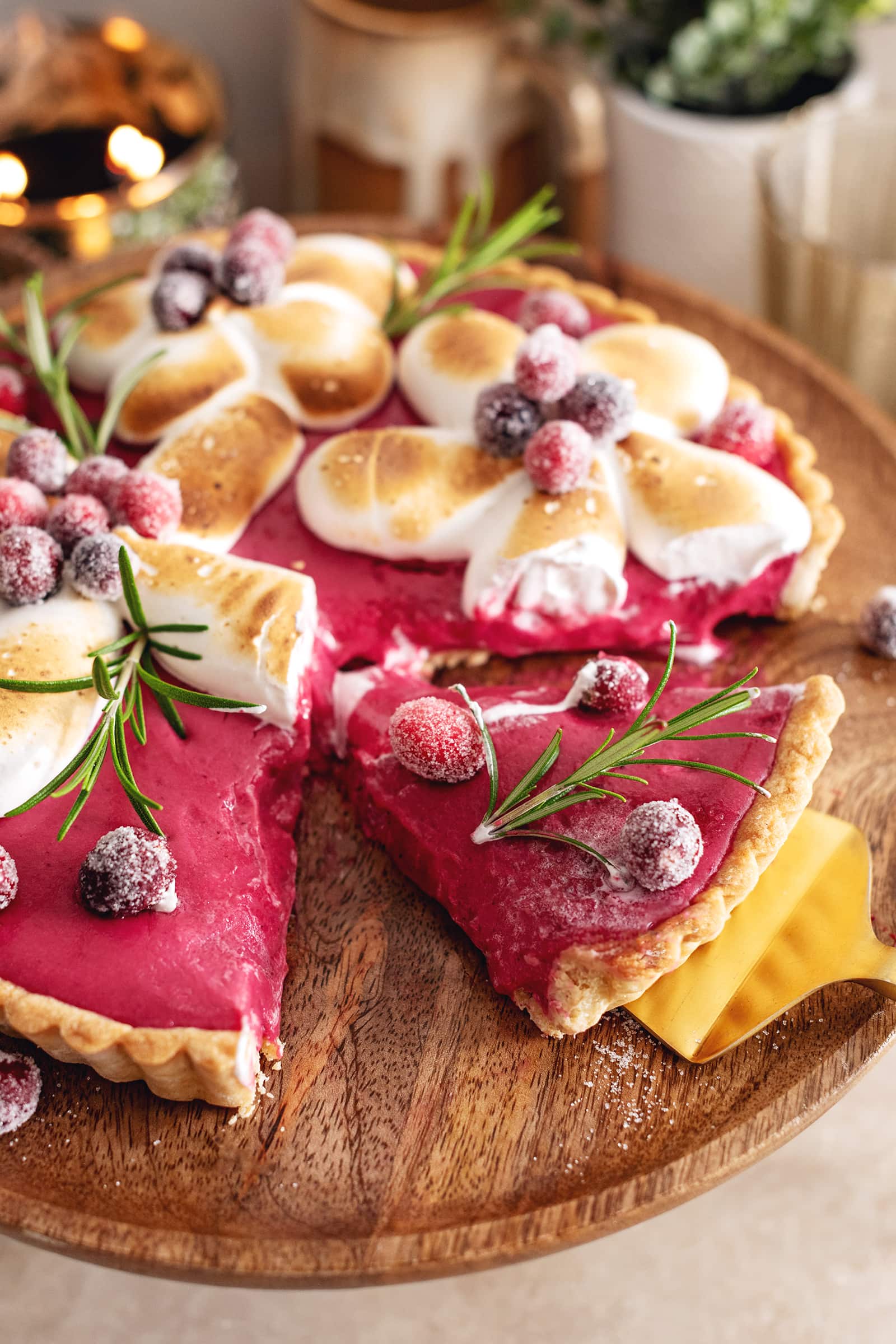 A slice of cranberry meringue tart cut from the rest of the tart.