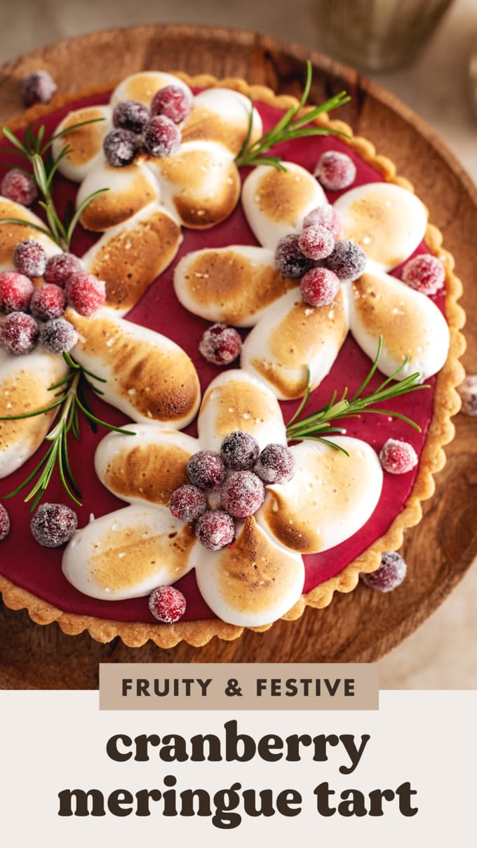Toasted meringue piped in the shape of flowers on top of a cranberry curd tart.