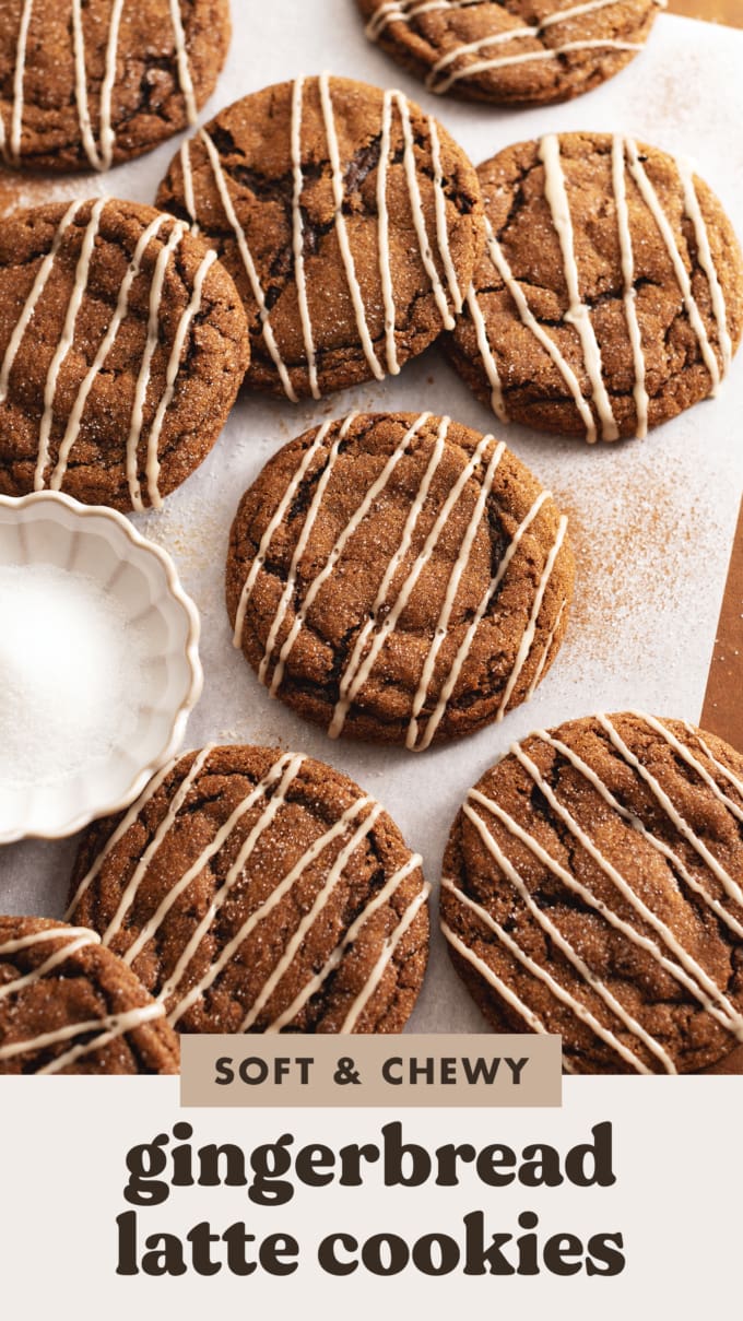 Several gingerbread latte cookies scattered on parchment paper with a small bowl of sugar.