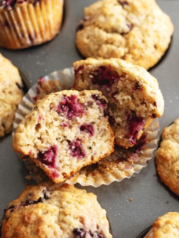 A banana blackberry oatmeal muffin cut in half to show the texture inside.