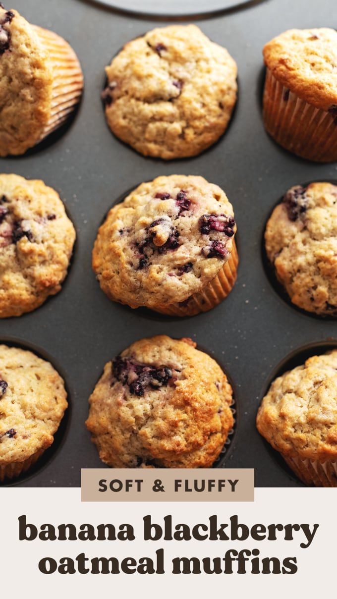 Banana blackberry oatmeal muffins in a muffin pan with some muffins tilted out of the pan.
