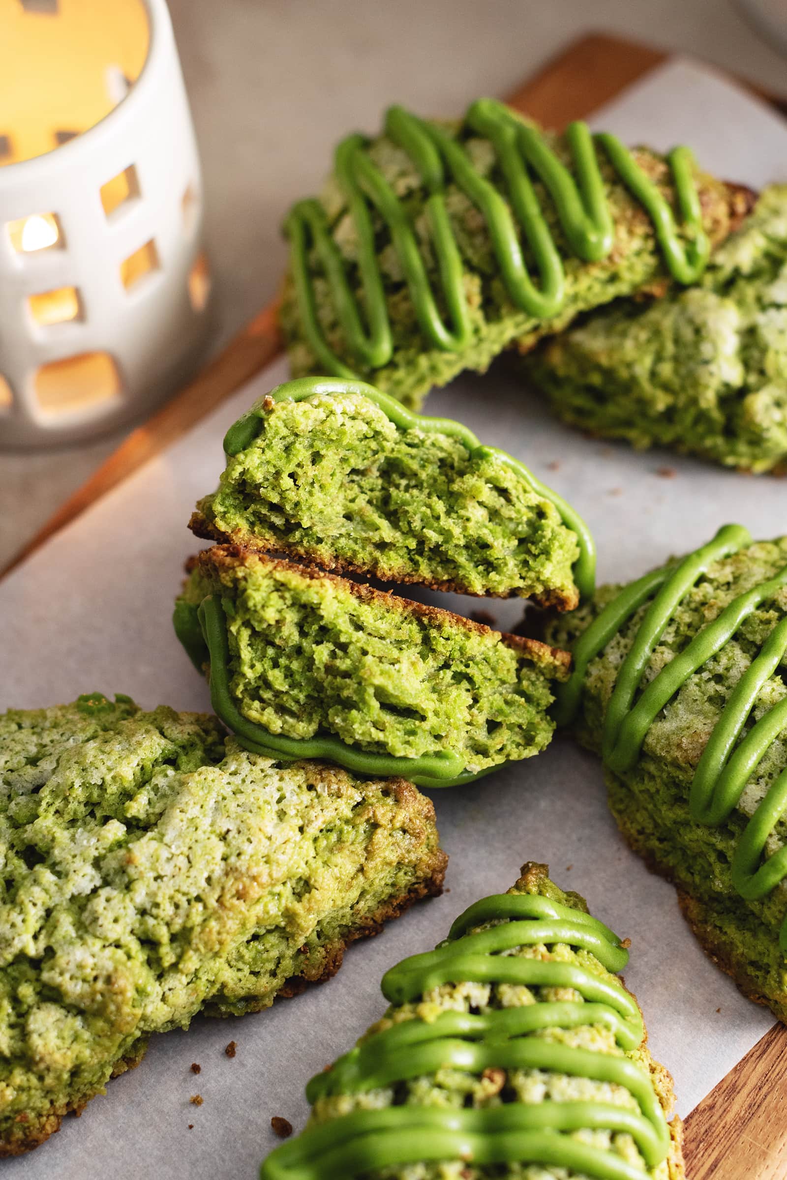 A matcha scone cut in half to show the fluffy texture inside.