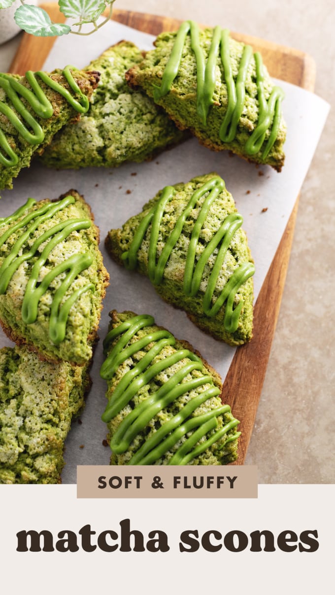 Matcha scones drizzled with matcha icing scattered on a wooden board.
