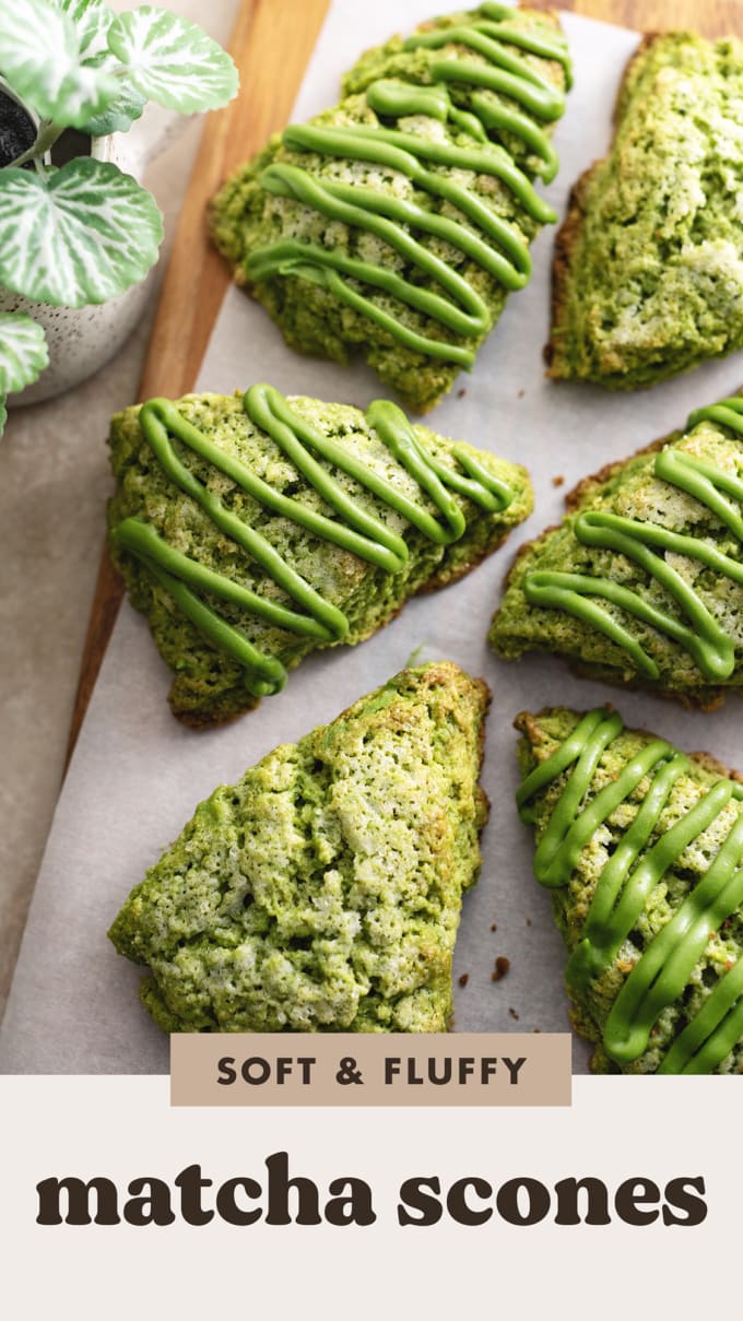 Matcha scones drizzled with matcha icing scattered on a wooden board.