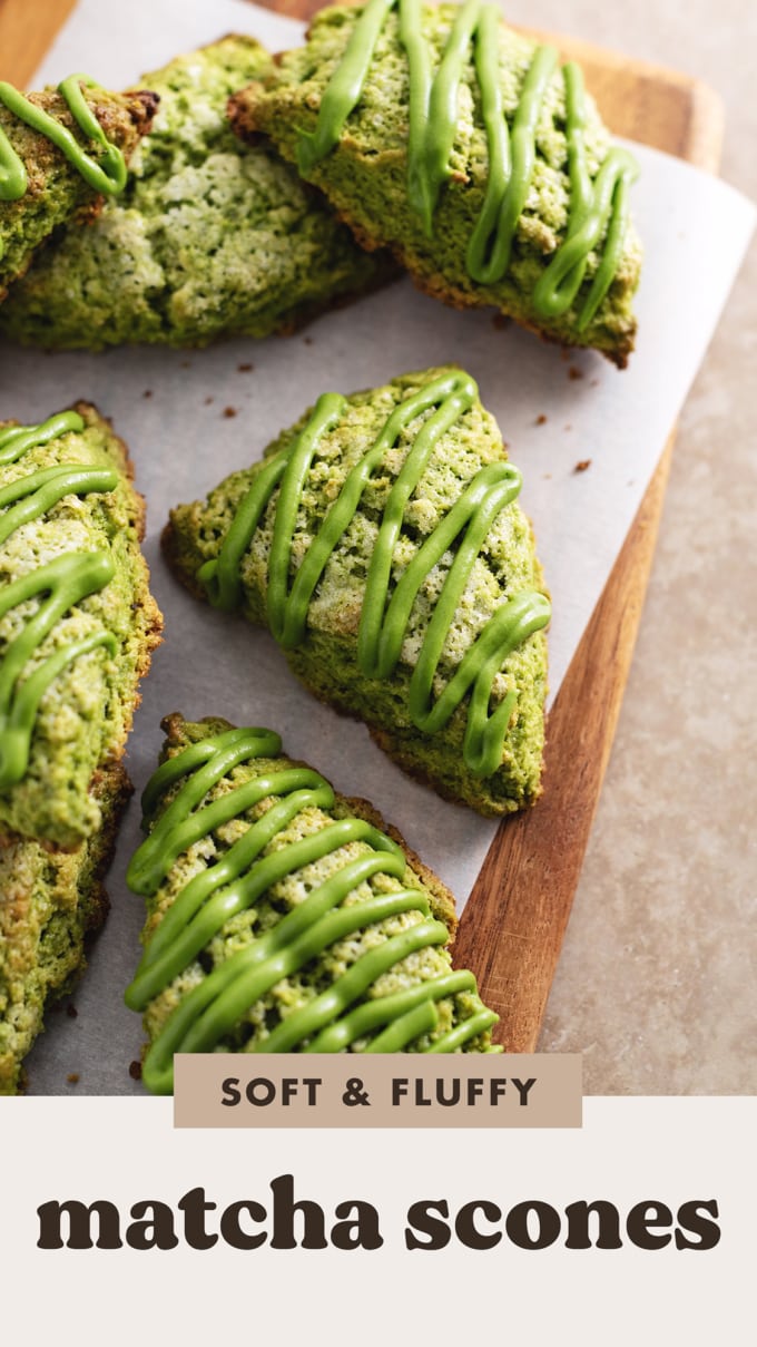 Matcha scones drizzled with matcha icing scattered on a wooden board.