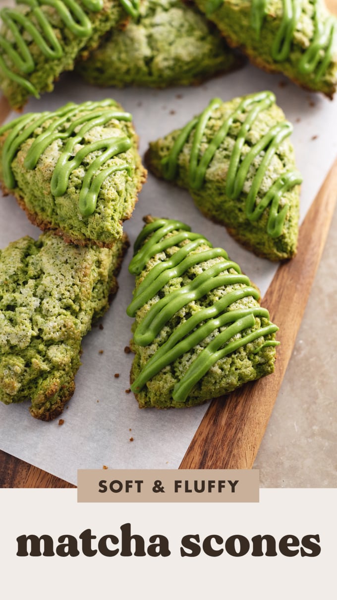 Matcha scones drizzled with matcha icing scattered on a wooden board.